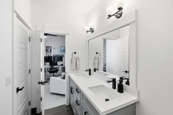 a bathroom with a sink a mirror a vanity and shower