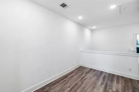 a view of room with wooden floor