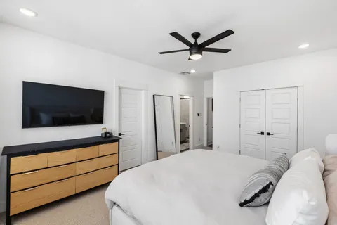 a bedroom with a bed and a flat screen tv