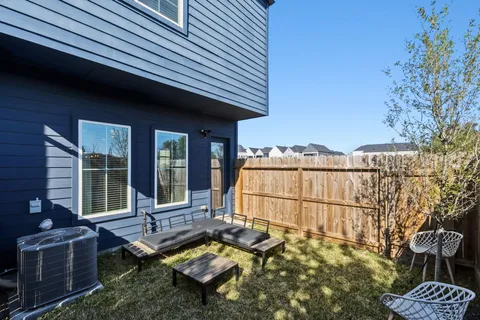 a backyard of a house with outdoor seating
