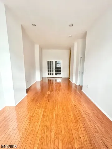 a view of a big room with wooden floor and windows