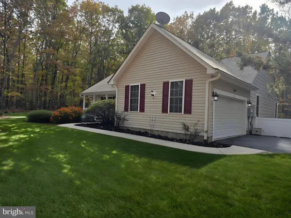 a view of a house with a yard and pathway