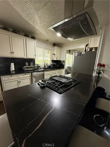 a kitchen with table and chairs