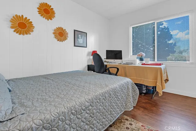 a bed room with a bed and a chair