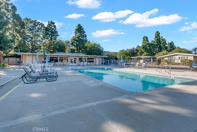 a view of a swimming pool with outdoor seating