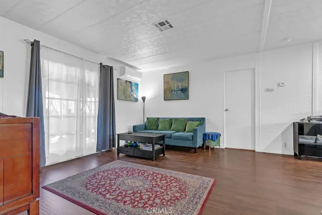 a living room with furniture rug and window