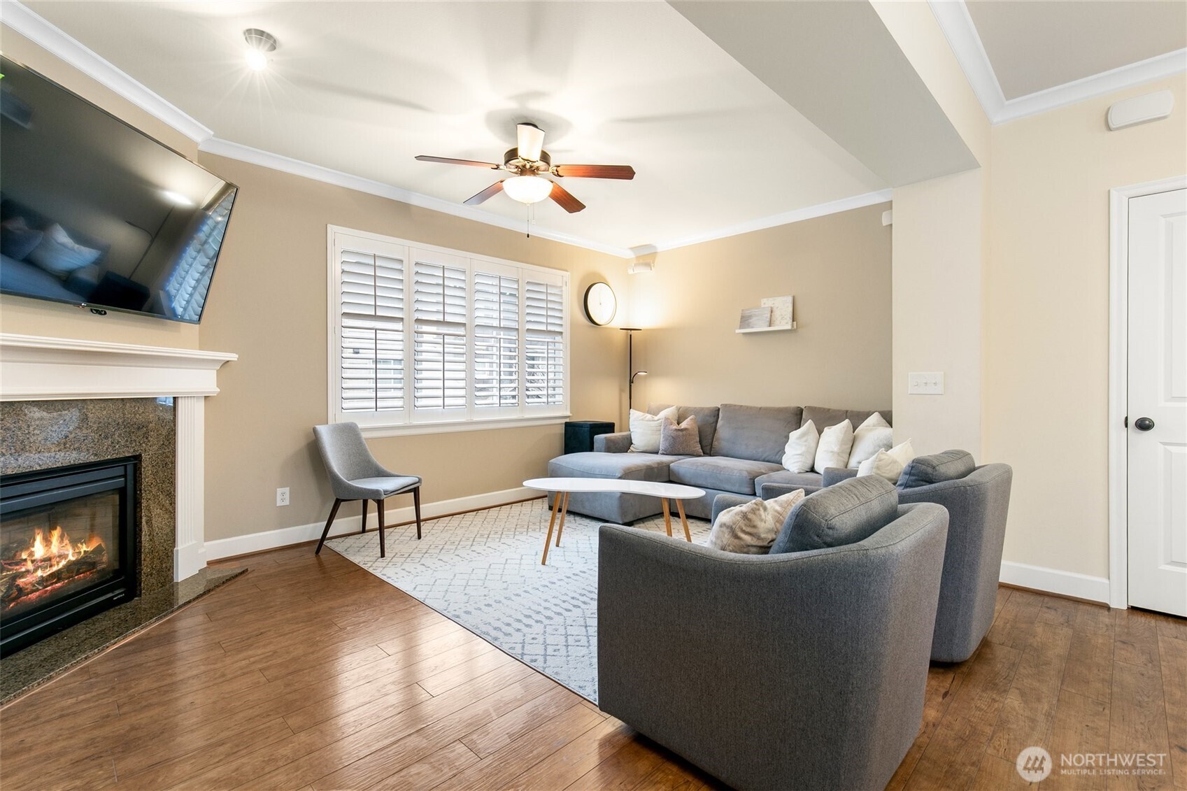 320 Chelan Place Northeast, Unit H1 Renton, WA 98059 - Photo 12 of 30 a living room with furniture a flat screen tv and a fireplace