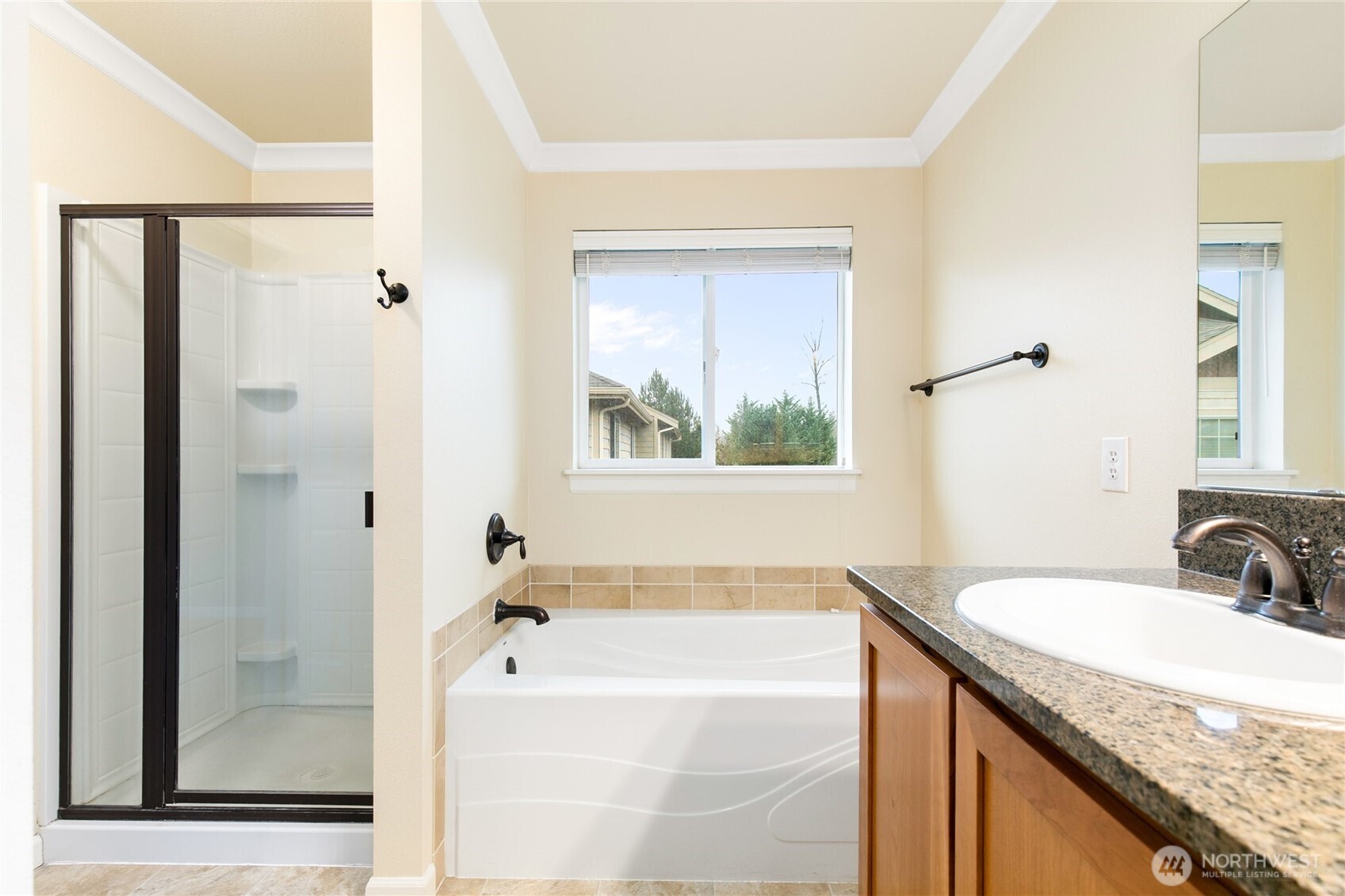 320 Chelan Place Northeast, Unit H1 Renton, WA 98059 - Photo 19 of 30 a bathroom with a granite countertop sink mirror and a bathtub