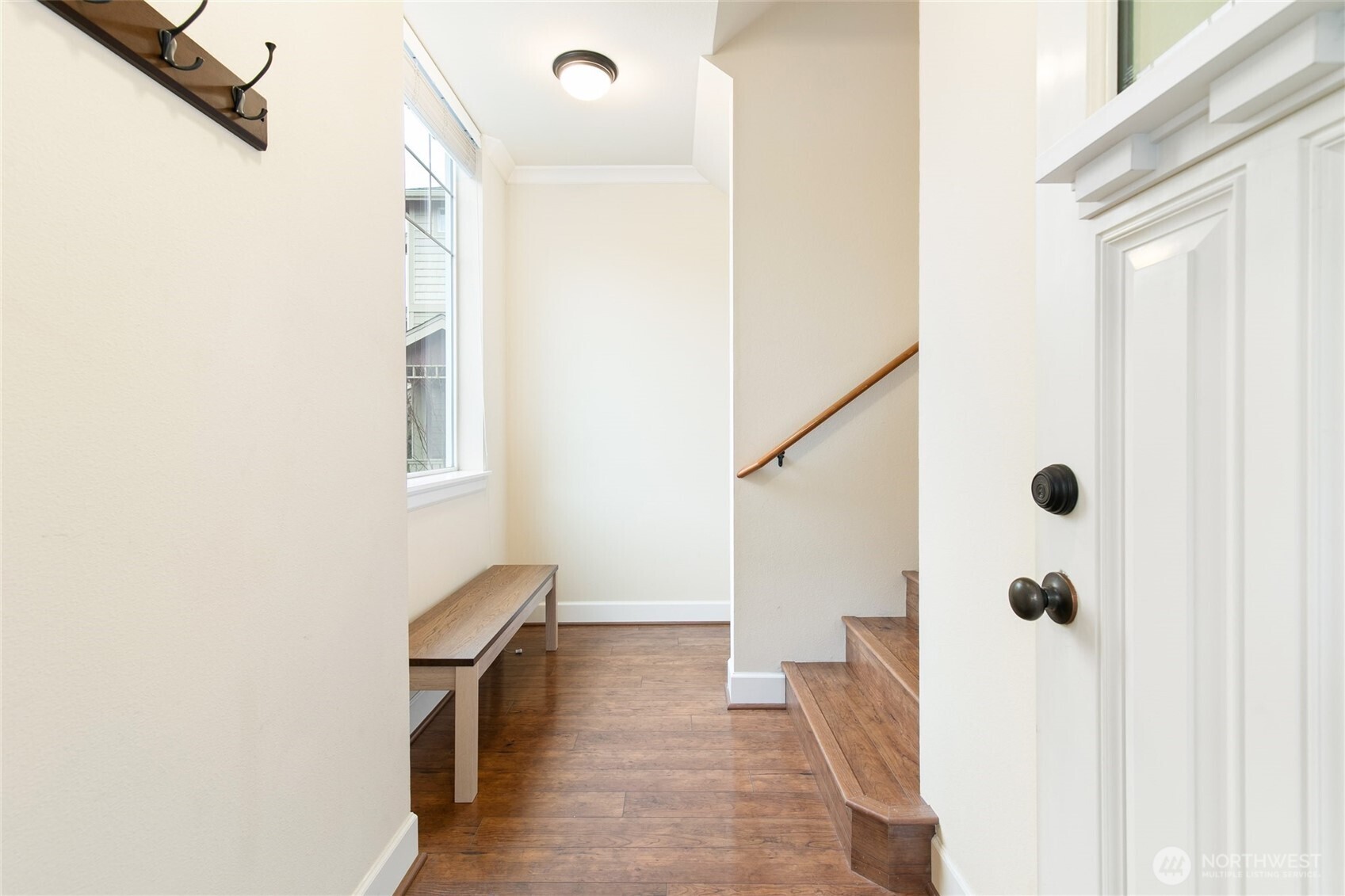 320 Chelan Place Northeast, Unit H1 Renton, WA 98059 - Photo 4 of 30 a view of a hallway with wooden floor and staircase