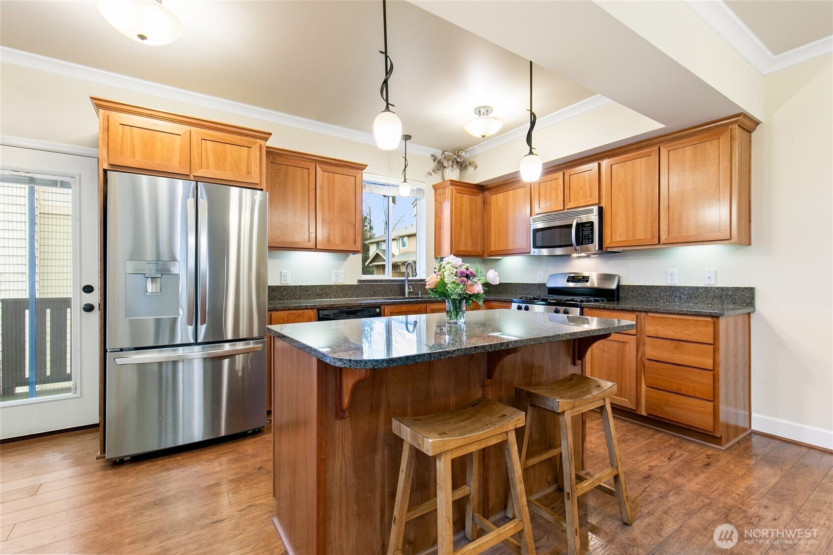 320 Chelan Place Northeast, Unit H1 Renton, WA 98059 - Photo 8 of 30 a kitchen with stainless steel appliances granite countertop a stove a sink and a refrigerator