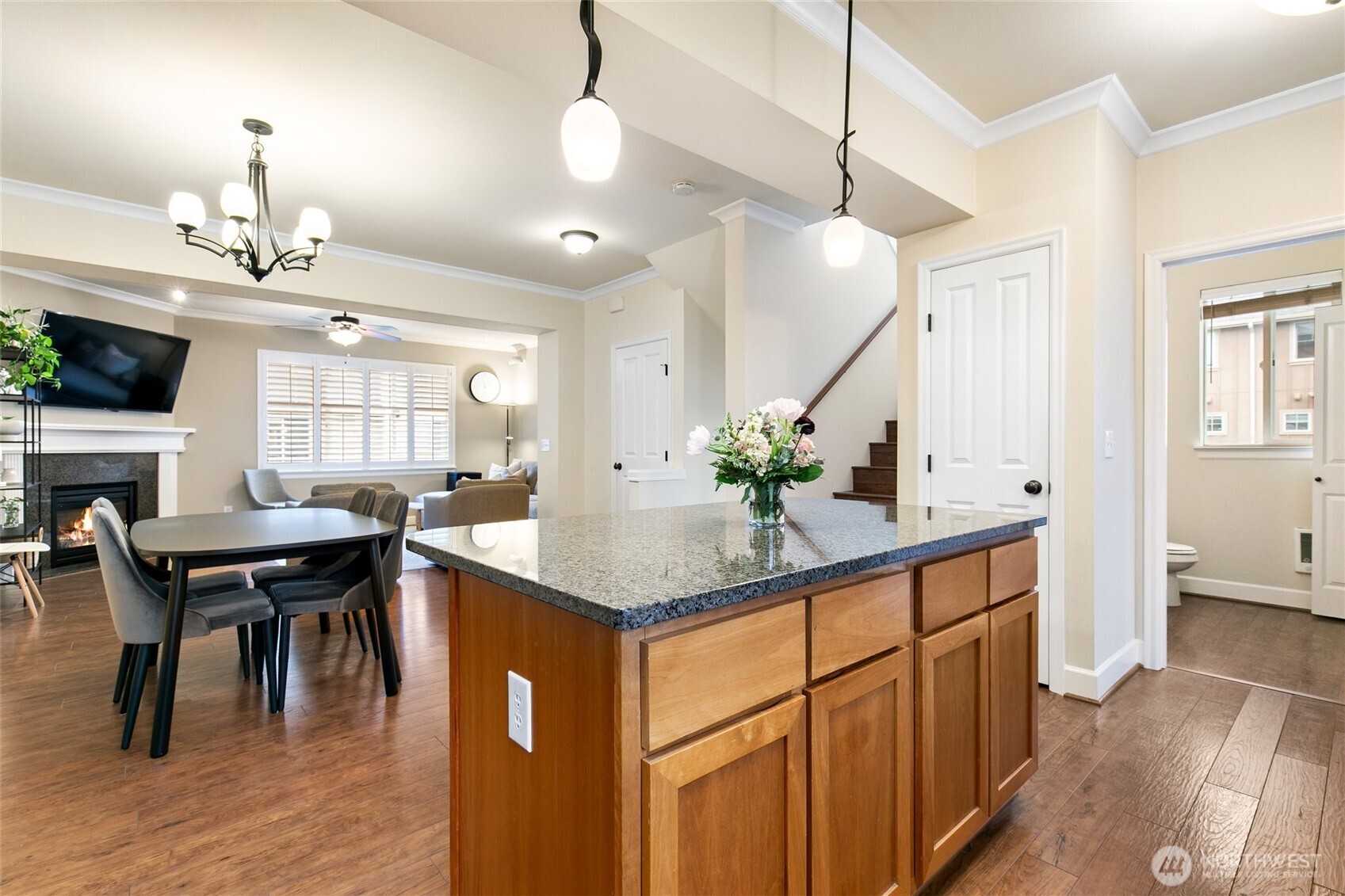 320 Chelan Place Northeast, Unit H1 Renton, WA 98059 - Photo 10 of 30 a kitchen with kitchen island granite countertop a table chairs sink and cabinets