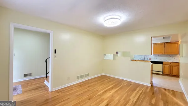 a view of a kitchen with a sink and a stove top oven