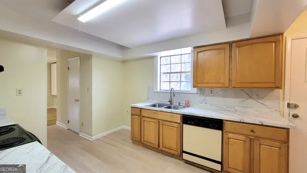 a kitchen with a sink stove and cabinets