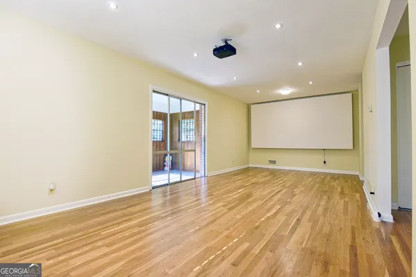 a view of an empty room with wooden floor