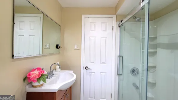 a bathroom with a sink mirror and vanity