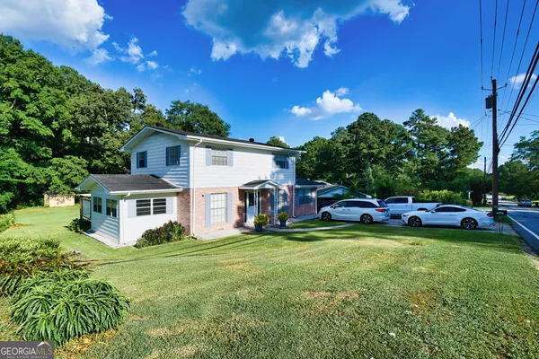 a view of a house with swimming pool and sitting area