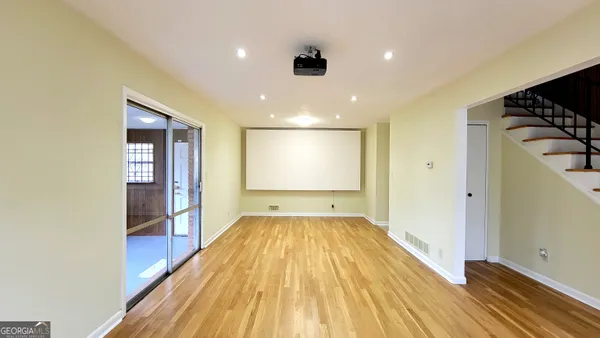 a view of a room with wooden floor and staircase