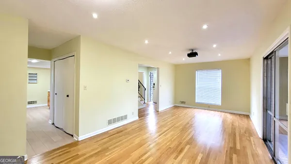 a view of hallway with wooden floor