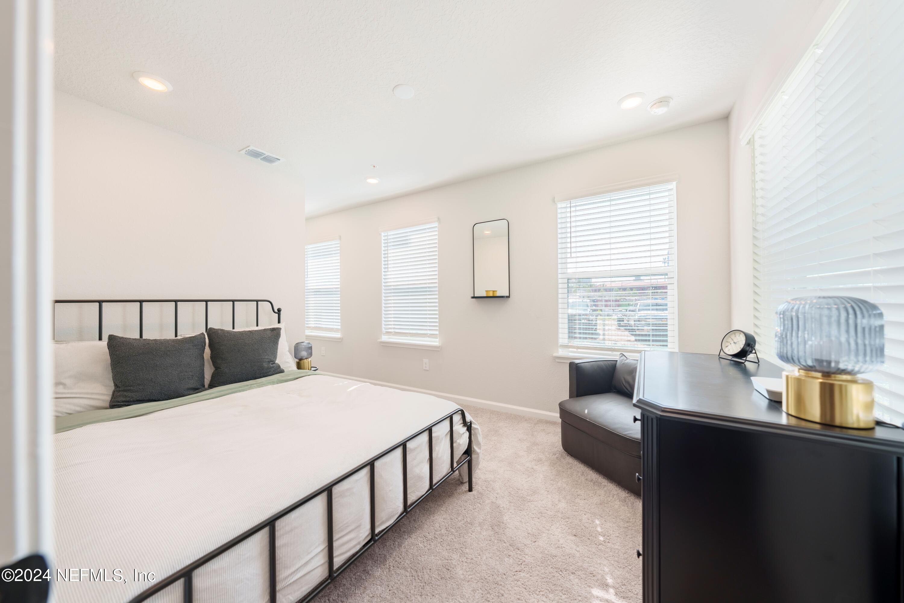159 Barstow Place Jacksonville, FL 32204 - Photo 8 of 35 a bedroom with double bed and a window