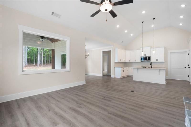 150 Doris Path Temple, GA 30179 - Photo 11 of 36 a view of a kitchen with a refrigerator wooden floor and a window