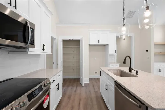 a kitchen with a sink and a stove top oven