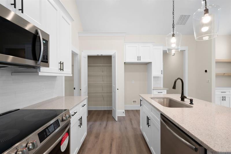 150 Doris Path Temple, GA 30179 - Photo 17 of 36 a kitchen with a sink and a stove top oven