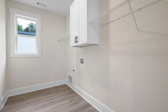 a view of small space with wooden floor and a window