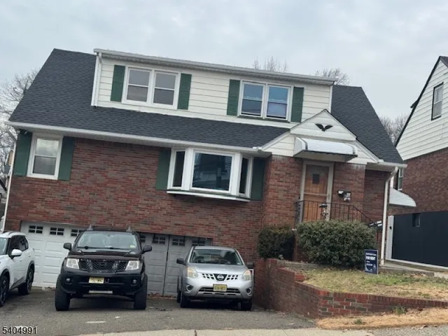 a car parked in front of a brick house
