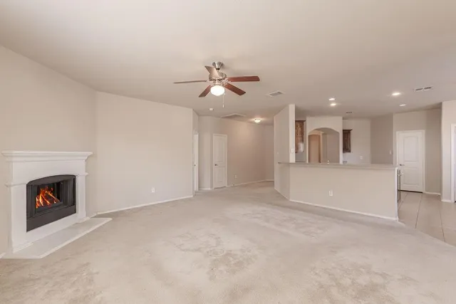 a view of an empty room with a fireplace