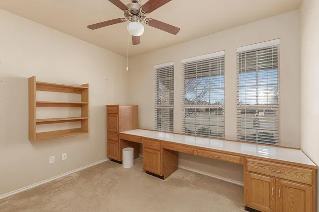 a room with pool table and windows