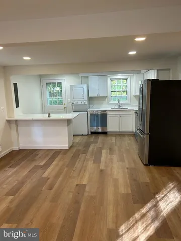 a view of a kitchen with a sink and a refrigerator