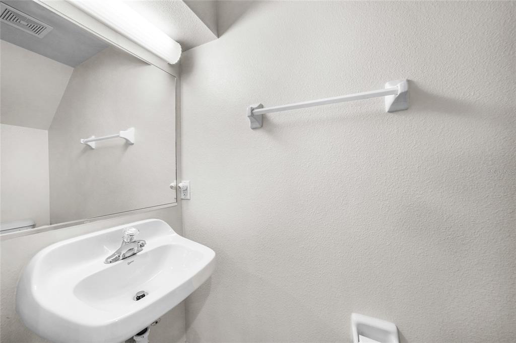 1246 Rio De Janeiro Avenue, Unit 505 Punta Gorda, FL 33983 - Photo 11 of 49 a bathroom with a sink and a mirror