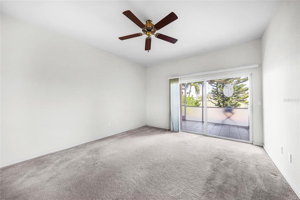 1246 Rio De Janeiro Avenue, Unit 505 Punta Gorda, FL 33983 - Photo 14 of 49 an empty room with chandelier fan and windows