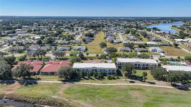 an aerial view of a residential apartment building with a yard