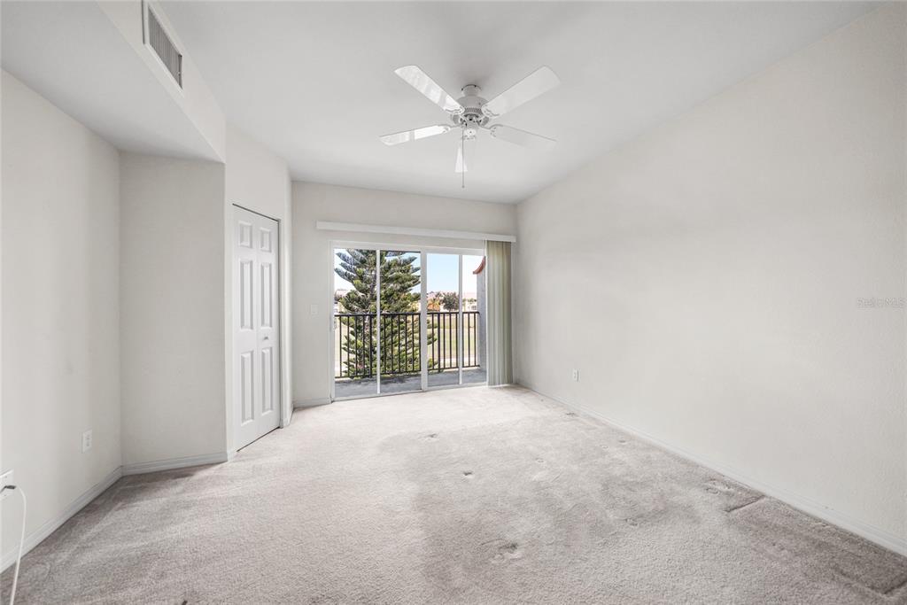 1246 Rio De Janeiro Avenue, Unit 505 Punta Gorda, FL 33983 - Photo 21 of 49 an empty room with windows and ceiling fan