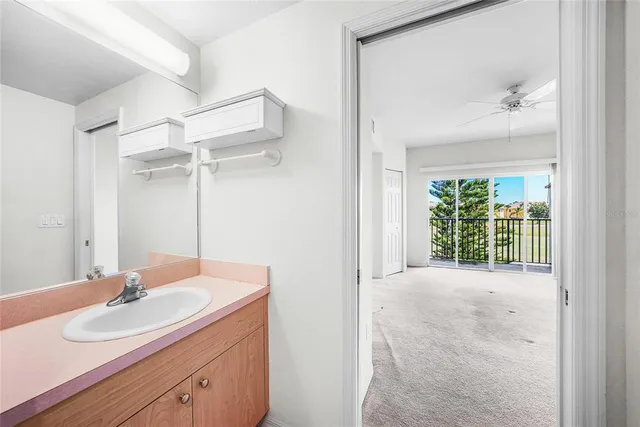 an aerial view of a city with lots of residential buildings ocean and mountain view in back