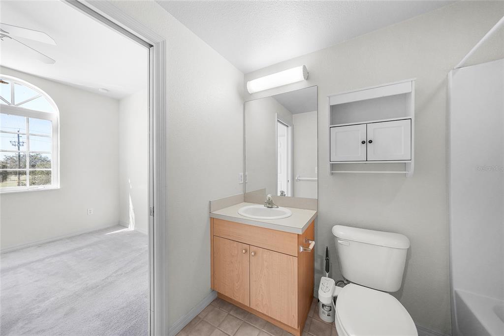 1246 Rio De Janeiro Avenue, Unit 505 Punta Gorda, FL 33983 - Photo 29 of 49 a bathroom with a toilet sink and mirror