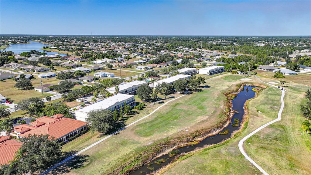 1246 Rio De Janeiro Avenue, Unit 505 Punta Gorda, FL 33983 - Photo 38 of 49 an aerial view of residential houses with outdoor space and trees