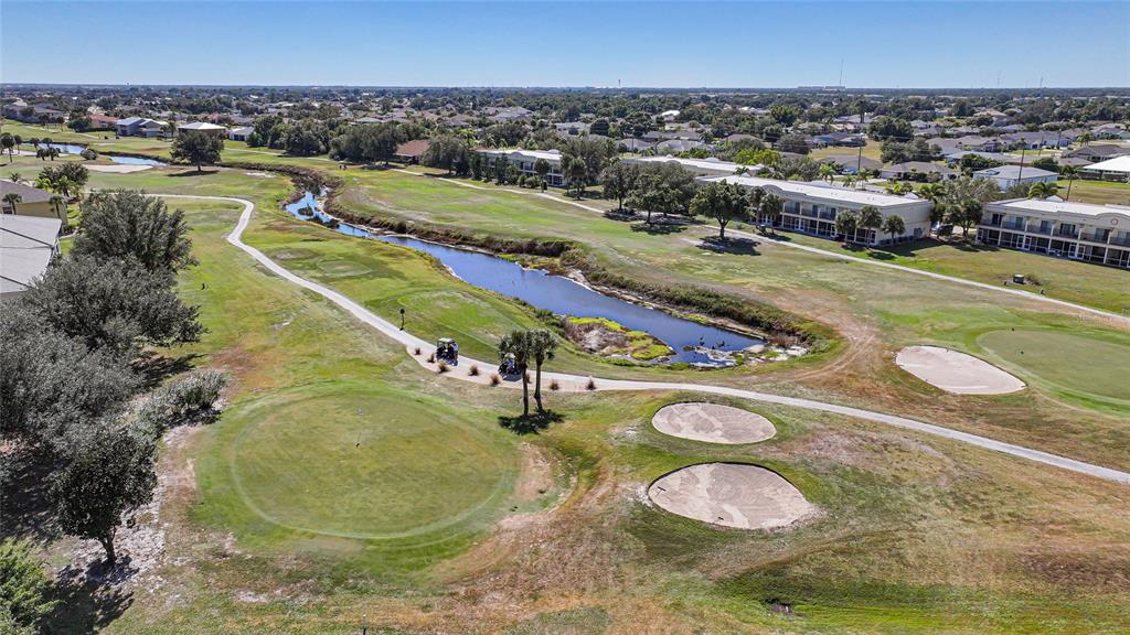 1246 Rio De Janeiro Avenue, Unit 505 Punta Gorda, FL 33983 - Photo 43 of 49 an aerial view of a swimming pool with a yard