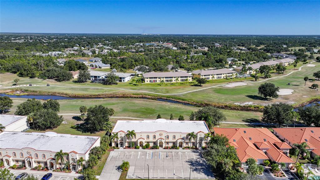 1246 Rio De Janeiro Avenue, Unit 505 Punta Gorda, FL 33983 - Photo 46 of 49 an aerial view of a city with lots of residential buildings ocean and mountain view in back