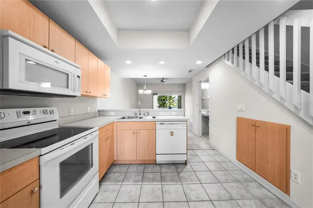 a kitchen with stainless steel appliances granite countertop a stove sink and cabinets