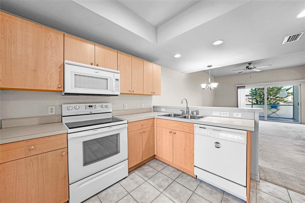 1246 Rio De Janeiro Avenue, Unit 505 Punta Gorda, FL 33983 - Photo 9 of 49 a kitchen with stainless steel appliances granite countertop a stove sink and cabinets