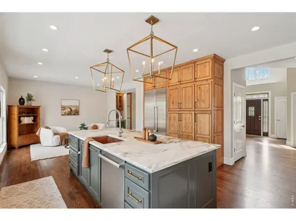 a kitchen that has a kitchen island wooden cabinets and a stove