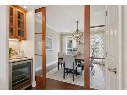 a view of a dining room with furniture and a window
