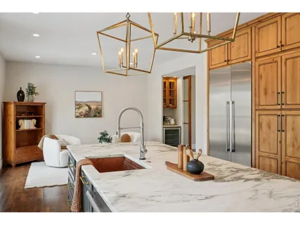 a living room with furniture a flat screen tv and kitchen view