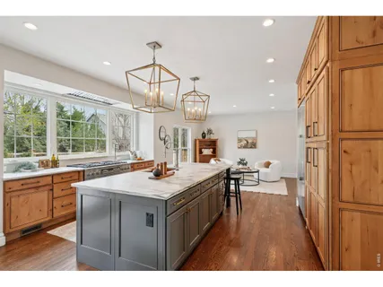 a kitchen with a sink a counter space appliances and cabinets