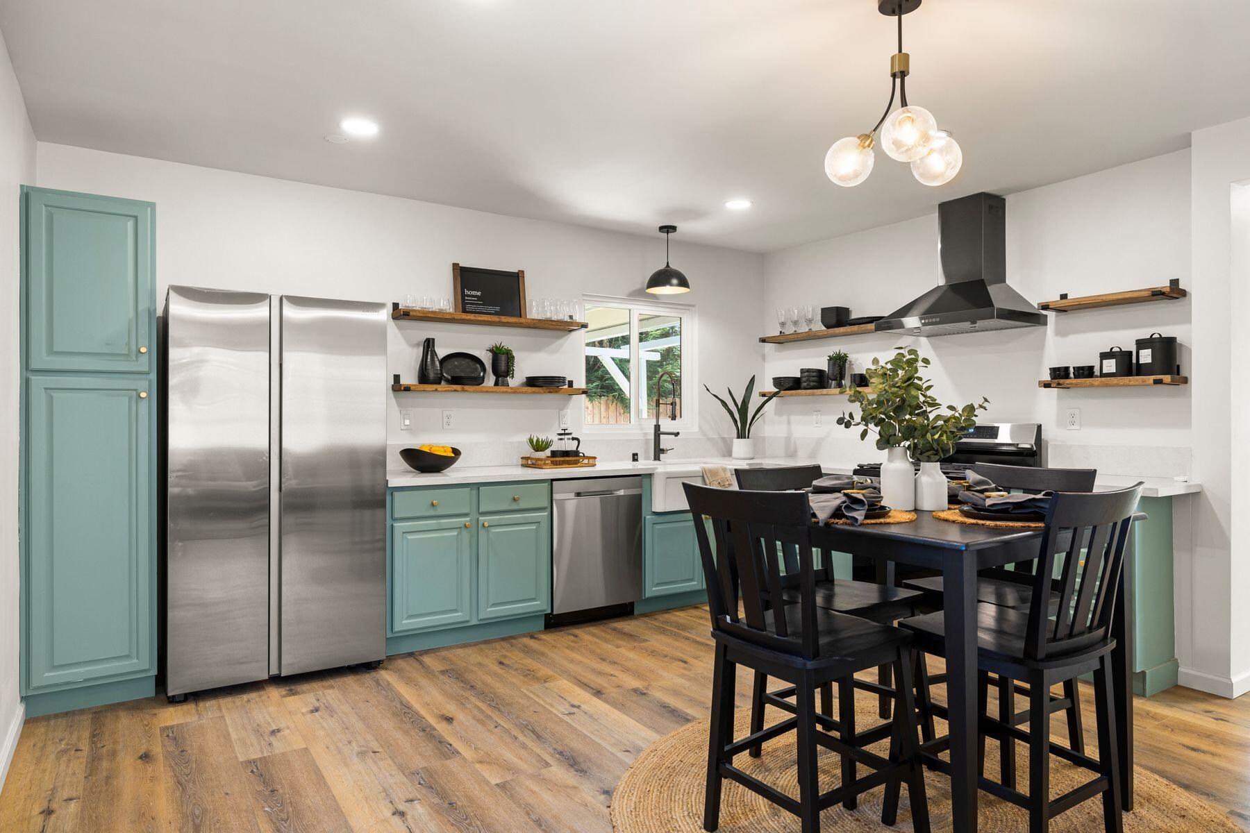 a kitchen with a table and chairs in it