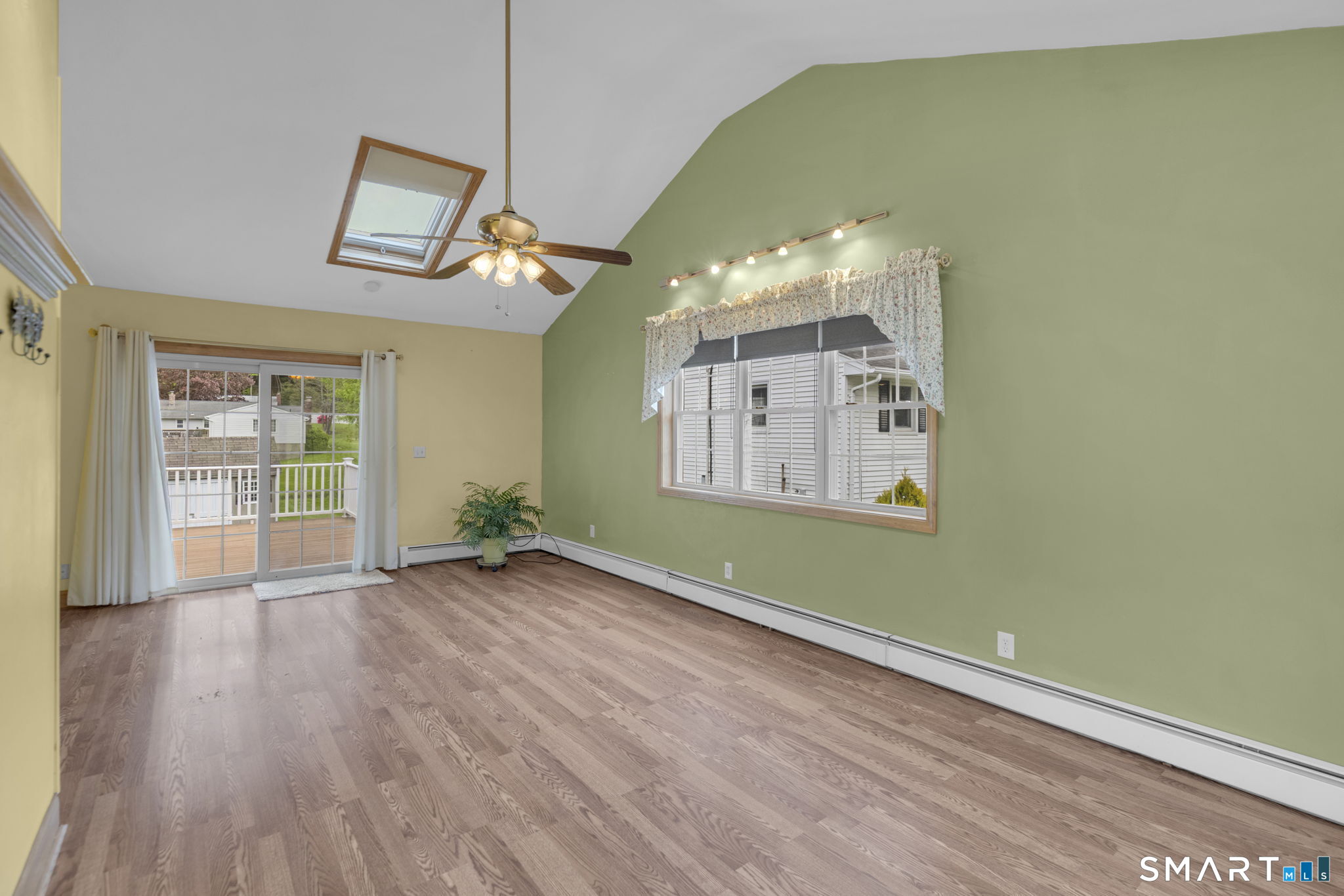 102 Wayne Lane Meriden, CT 06450 - Photo 28 of 36 a view of a room with wooden floor a ceiling fan and windows