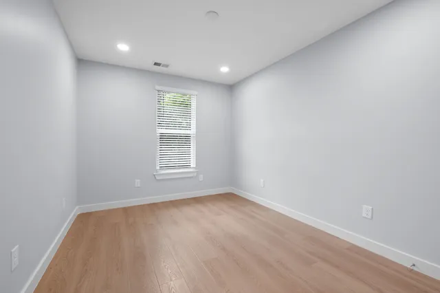 a view of hallway with wooden floor