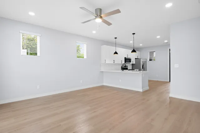 a view of a kitchen with a sink and a window
